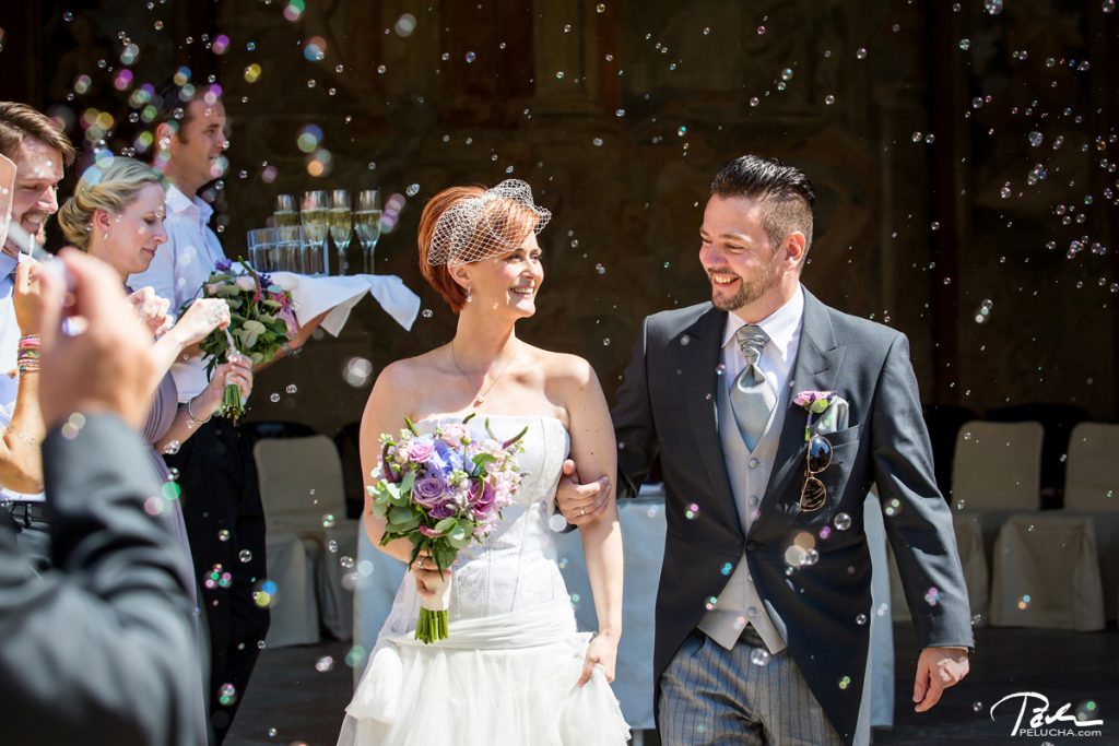guests throwing petals on newlyweds in the receiving line