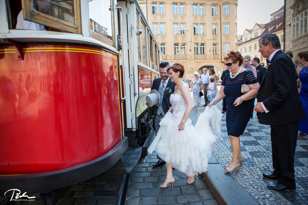bride's mother holding the veil as they enter the historical tram